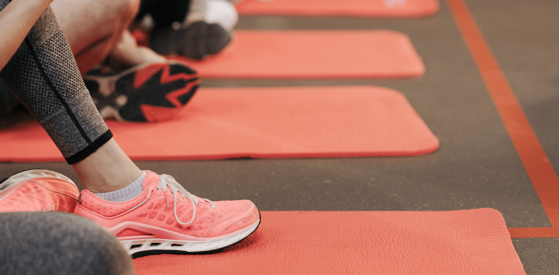 A woman sits in a group fitness class.