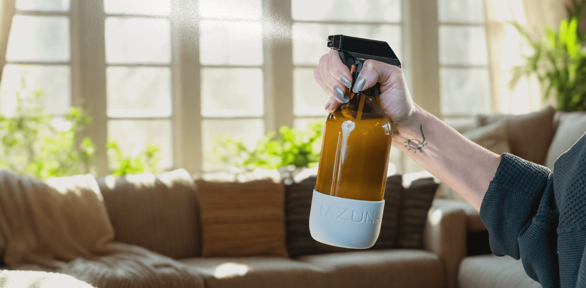 a woman spraying a non-toxic cleaner onto home surfaces